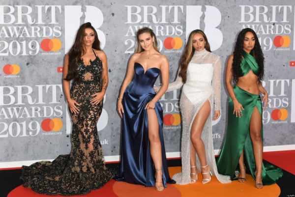 British group Little Mix attend the Brit Awards at O2 Arena in 2019. Jade (R) will read a children's story on 